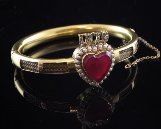 A Victorian high carat gold, seed pearl and diamond set mourning hinged bangle, gross 20.2 grams.